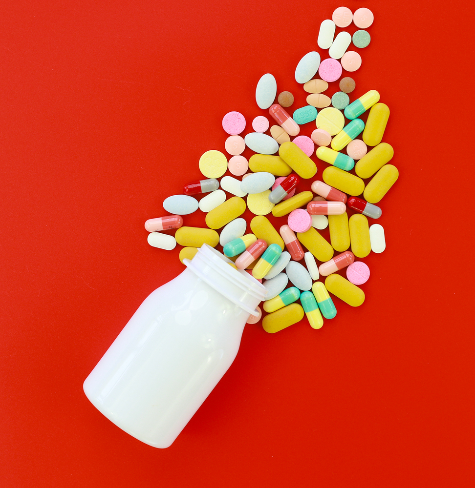 Pile,Of,Medical,Capsules,Pills,In,Red,And,White,Color