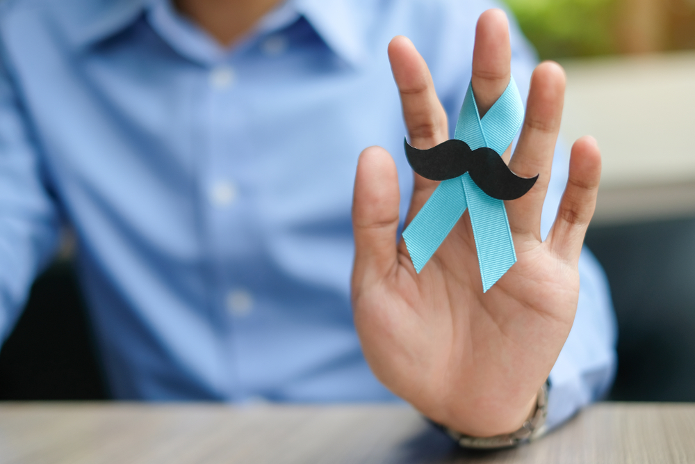 Prostate,Cancer,Awareness,,Man,Hand,Holding,Light,Blue,Ribbon,With